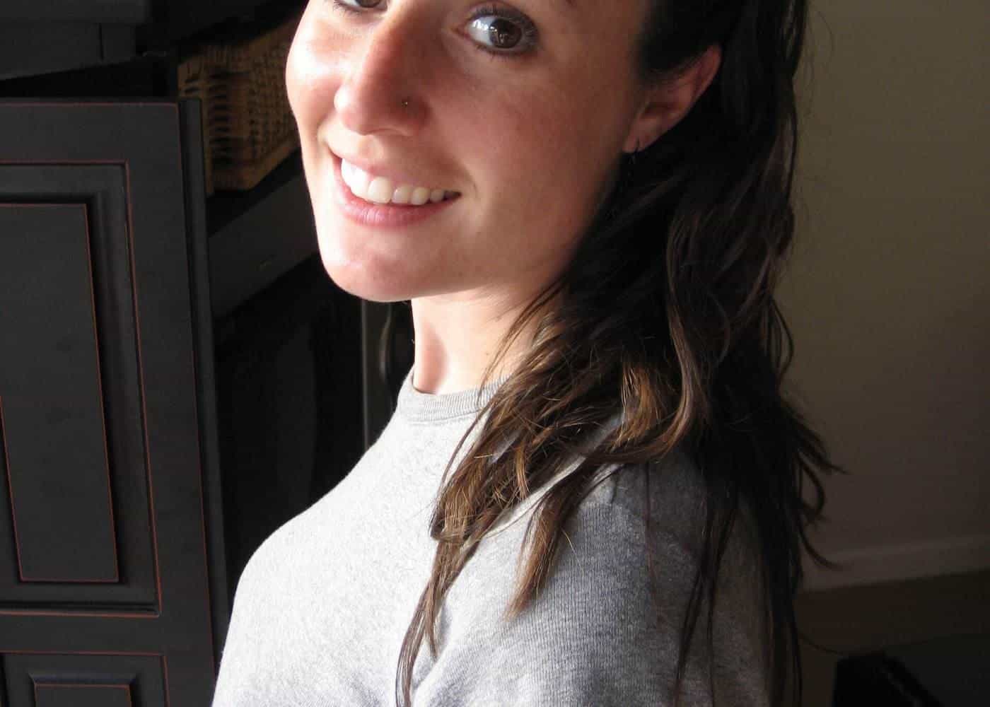 A smiling woman with long wavy hair