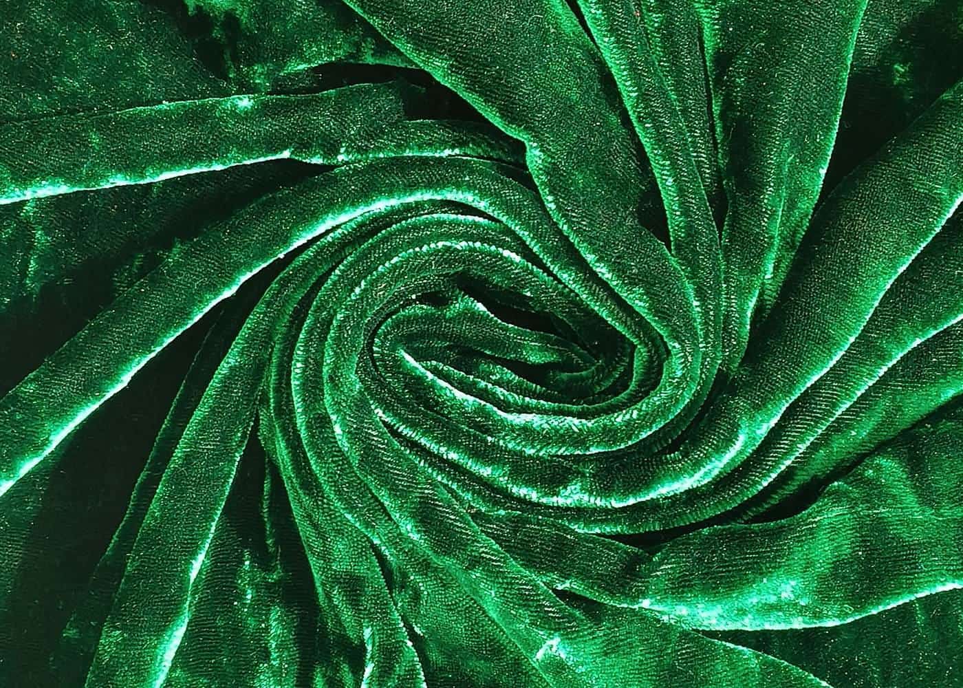Rich green velvet fabric folded into a swirl