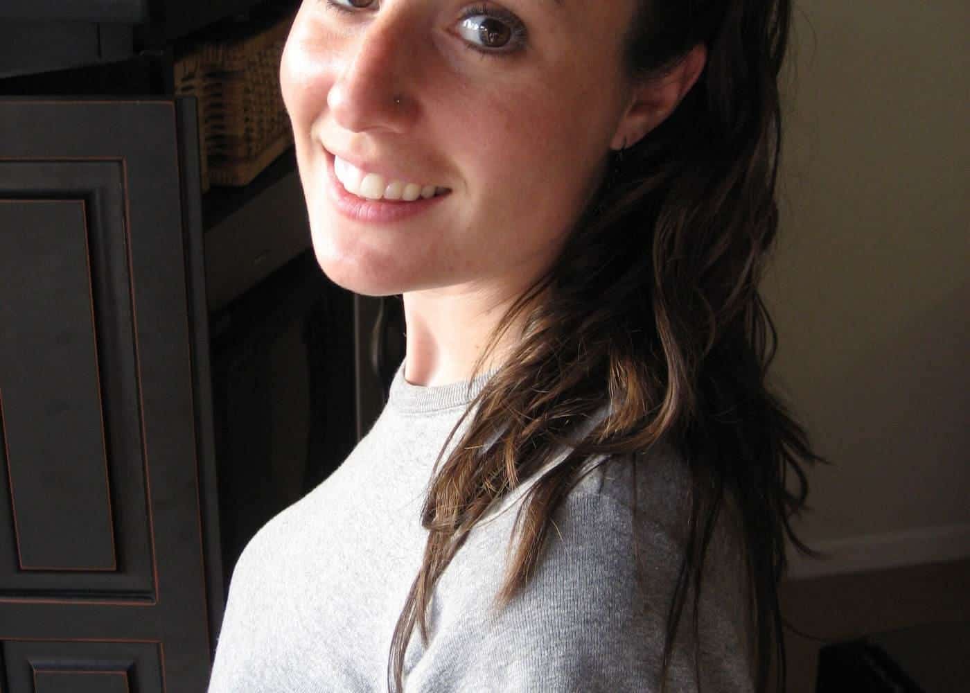 A smiling woman with long wavy hair